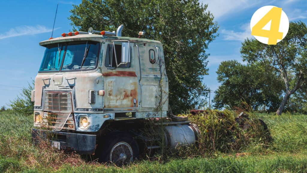 rusty semi truck in the yard